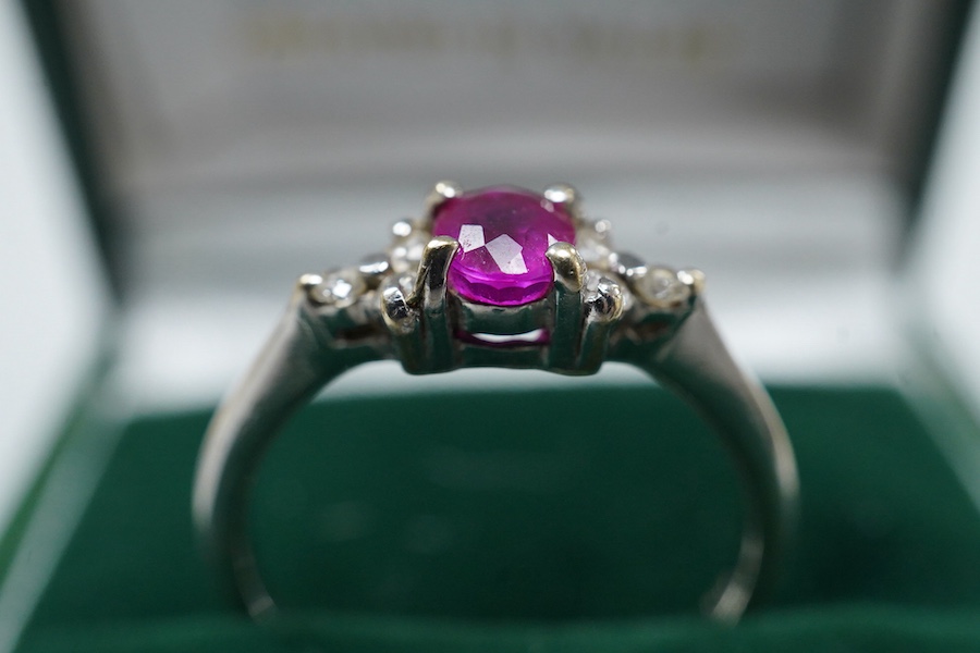 A cased late Victorian 9ct and single stone amethyst set bar brooch, 45mm, a cased yellow metal and single stone white opal set stick pin and a modern 18ct white gold, ruby and diamond cluster ring, size L/M.